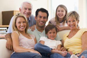 Extended Families In Living Room Smiling